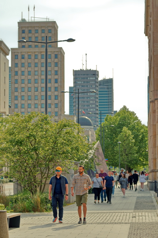 25 - Pedestrians walking on the sidewalk of a street in Warsaw